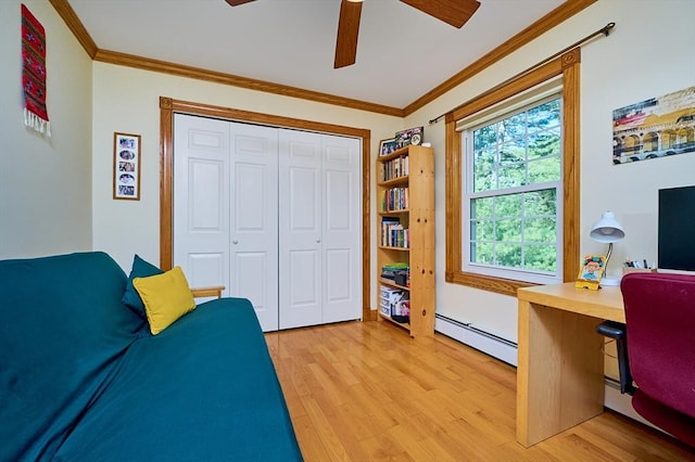 office space featuring ceiling fan, a baseboard heating unit, ornamental molding, and light wood-style flooring