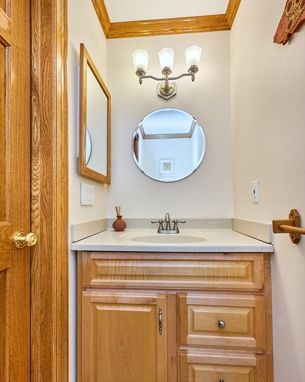 bathroom with vanity and ornamental molding