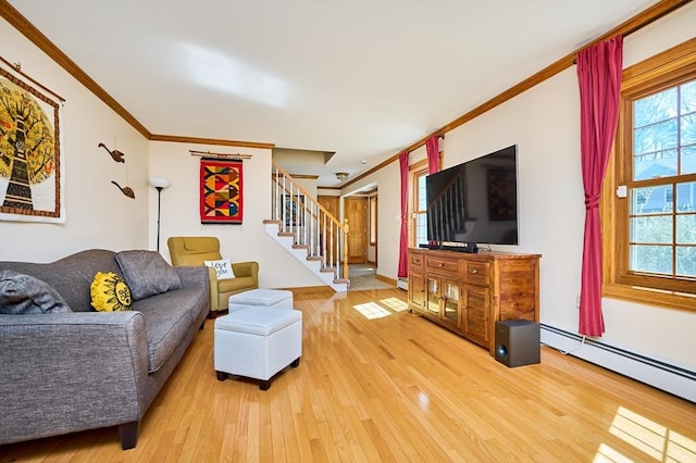 living area with light wood-type flooring, a baseboard radiator, crown molding, and stairway