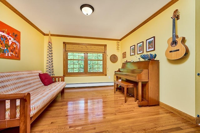 living area with baseboards, a baseboard radiator, ornamental molding, and wood finished floors