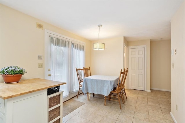 dining area with baseboards, light tile patterned floors, and visible vents