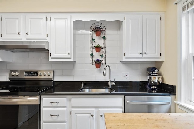 kitchen with stainless steel appliances, a sink, extractor fan, and white cabinets