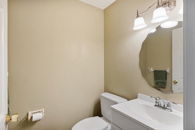 half bath featuring toilet and vanity