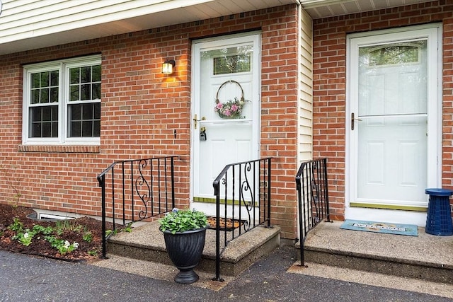 property entrance with brick siding