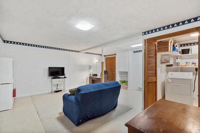 carpeted living room with a textured ceiling, baseboards, and washer / dryer