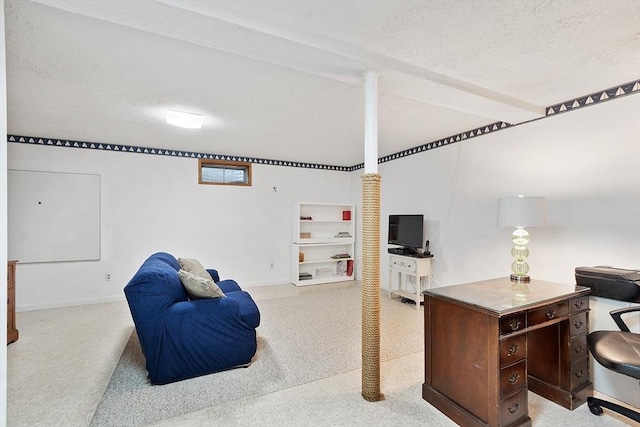 carpeted office with baseboards and a textured ceiling