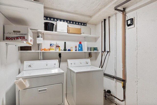 washroom with separate washer and dryer and laundry area