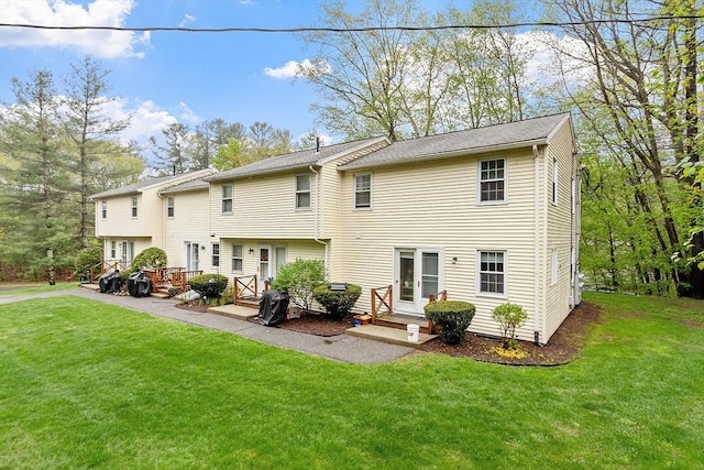 rear view of property with a lawn