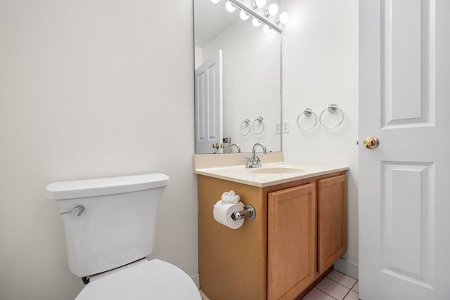 bathroom with tile patterned flooring, vanity, and toilet