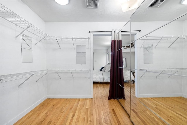 walk in closet featuring hardwood / wood-style flooring