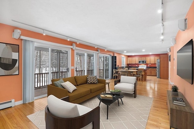 living room featuring light hardwood / wood-style floors and baseboard heating