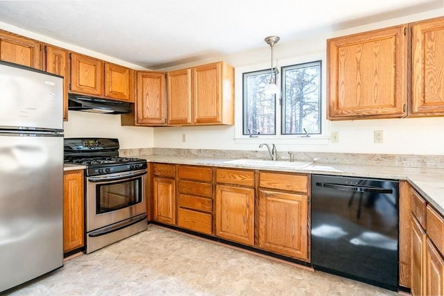 kitchen featuring pendant lighting, brown cabinets, stainless steel appliances, a sink, and under cabinet range hood