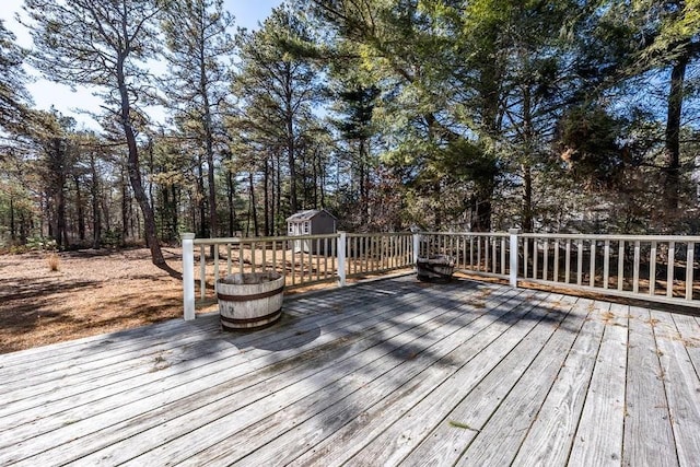 wooden terrace with an outbuilding and a storage unit