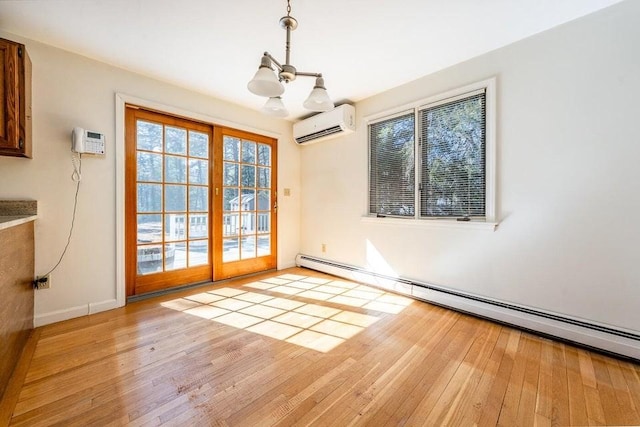 unfurnished dining area featuring a wall unit AC, a baseboard heating unit, baseboards, a wall mounted AC, and light wood finished floors