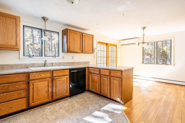 kitchen with black dishwasher, brown cabinets, a wall mounted air conditioner, a peninsula, and a sink