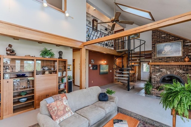 living room featuring high vaulted ceiling, a ceiling fan, a fireplace, and stairway