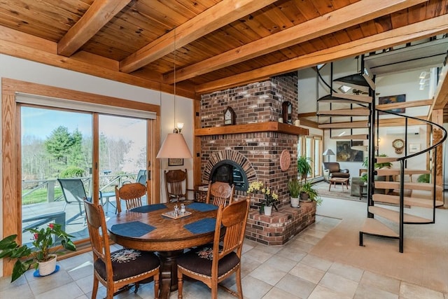 tiled dining space featuring wooden ceiling, beamed ceiling, stairs, and a fireplace