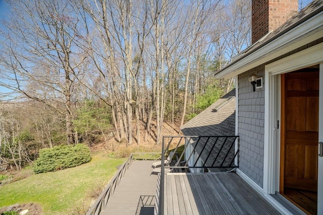 wooden terrace featuring a yard