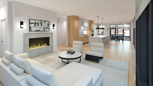 living room with light hardwood / wood-style floors and a premium fireplace