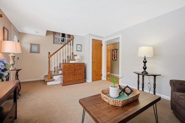 living room with light carpet, stairway, and baseboards