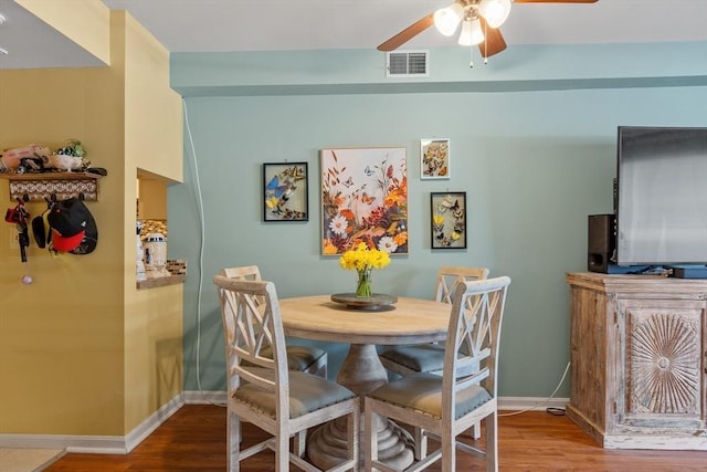 dining area featuring wood-type flooring and ceiling fan