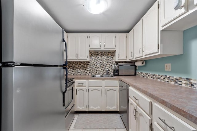 kitchen with sink, decorative backsplash, stainless steel appliances, and white cabinets