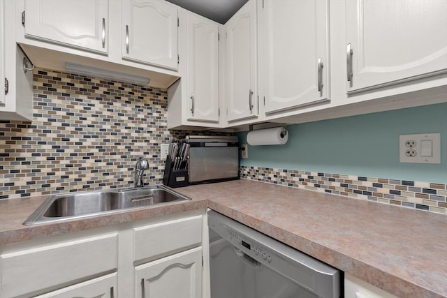 kitchen featuring white cabinetry, dishwasher, sink, and tasteful backsplash