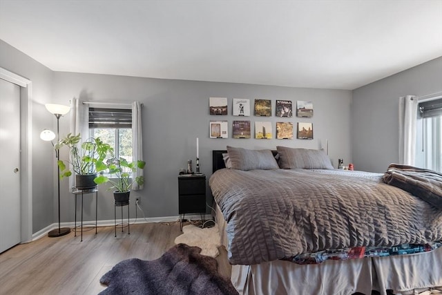 bedroom featuring light hardwood / wood-style floors and multiple windows