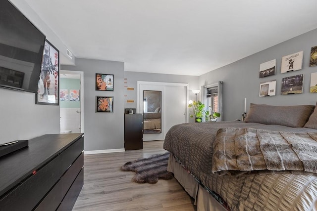 bedroom featuring hardwood / wood-style flooring and a closet