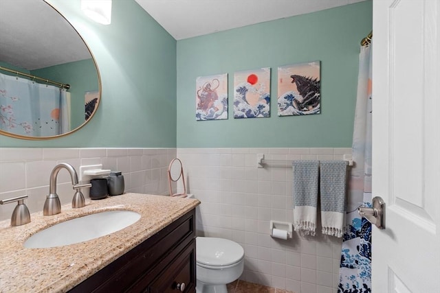 bathroom featuring vanity, toilet, and tile walls