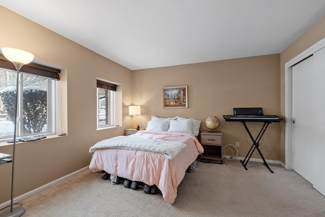 bedroom with light colored carpet and a closet