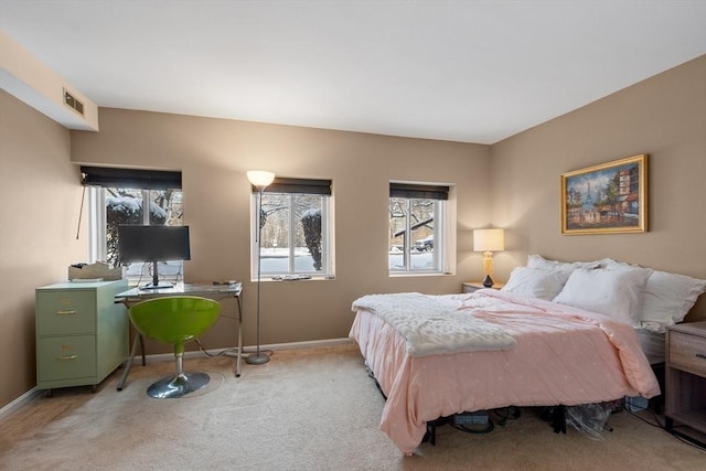 carpeted bedroom featuring multiple windows