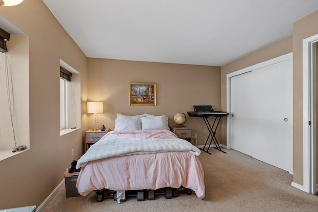 bedroom featuring light carpet and a closet