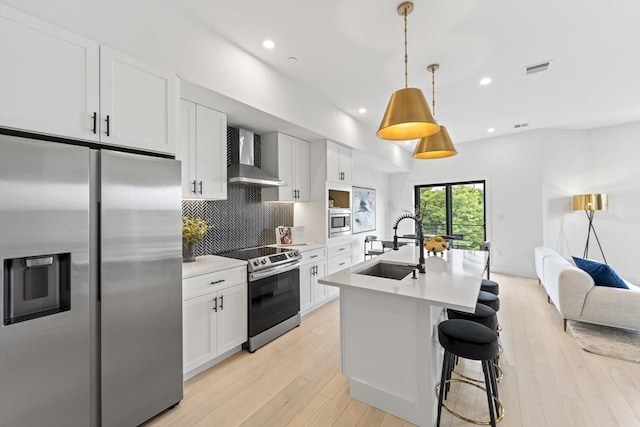 7 Wordsworth Unit Ph6, Boston, MA 02128 - kitchen with appliances with stainless steel finishes, wall chimney range hood, a sink, tasteful backsplash, and light countertops