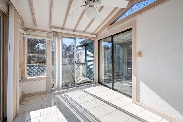 unfurnished sunroom featuring vaulted ceiling with beams and ceiling fan