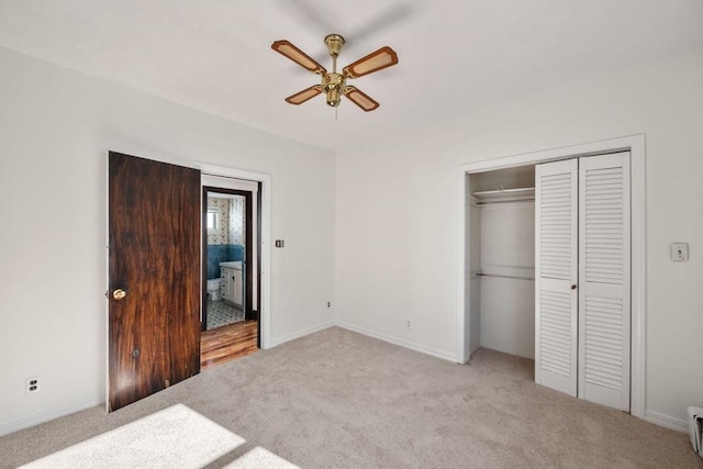 unfurnished bedroom featuring light carpet, a closet, and ceiling fan