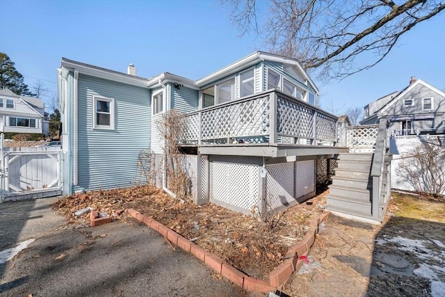 back of house featuring a deck