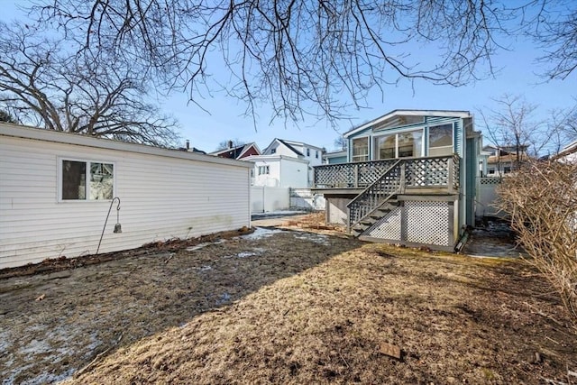 rear view of property featuring a wooden deck