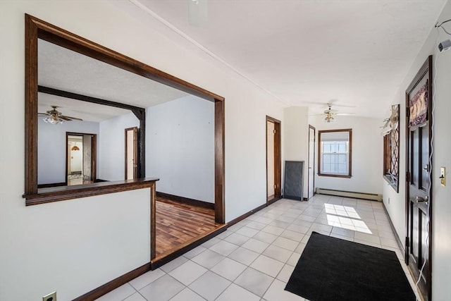 hall with light tile patterned flooring, a baseboard radiator, and beam ceiling