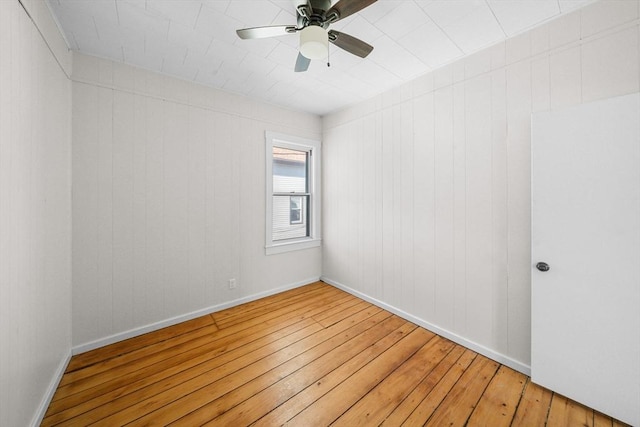 spare room with hardwood / wood-style flooring and ceiling fan