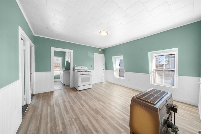 interior space featuring crown molding and light hardwood / wood-style flooring