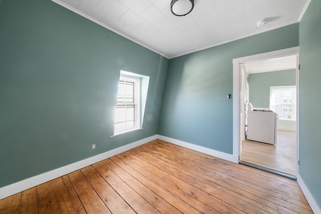 spare room featuring light wood-type flooring and ornamental molding