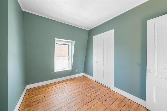 unfurnished bedroom featuring light hardwood / wood-style flooring and ornamental molding