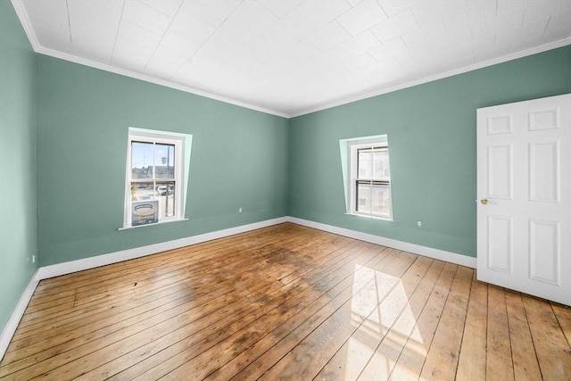 unfurnished room featuring crown molding and hardwood / wood-style floors