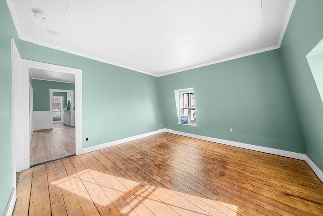 unfurnished room with crown molding and light hardwood / wood-style flooring