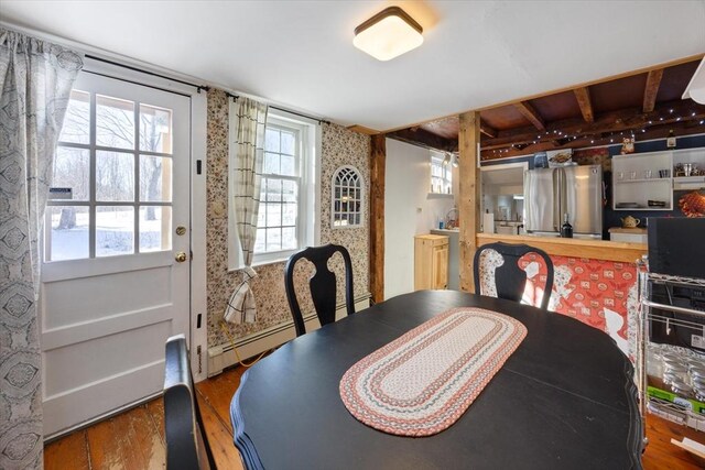 dining room featuring baseboard heating and wood finished floors