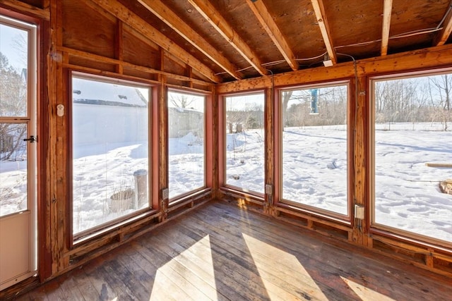 unfurnished sunroom featuring lofted ceiling