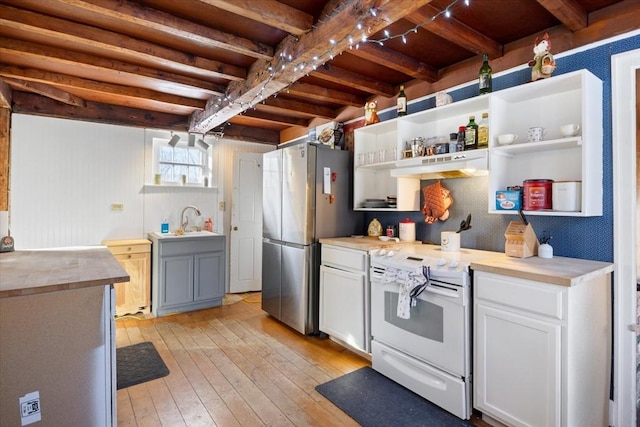 kitchen with beam ceiling, open shelves, white electric range, freestanding refrigerator, and light wood-type flooring