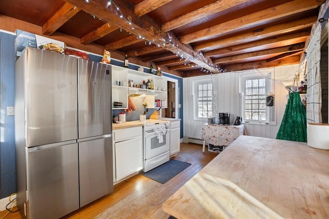 kitchen with a baseboard heating unit, white cabinets, freestanding refrigerator, light wood finished floors, and beamed ceiling