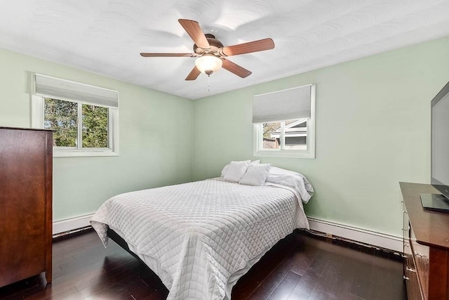 bedroom featuring wood-type flooring, baseboards, ceiling fan, baseboard heating, and a baseboard heating unit